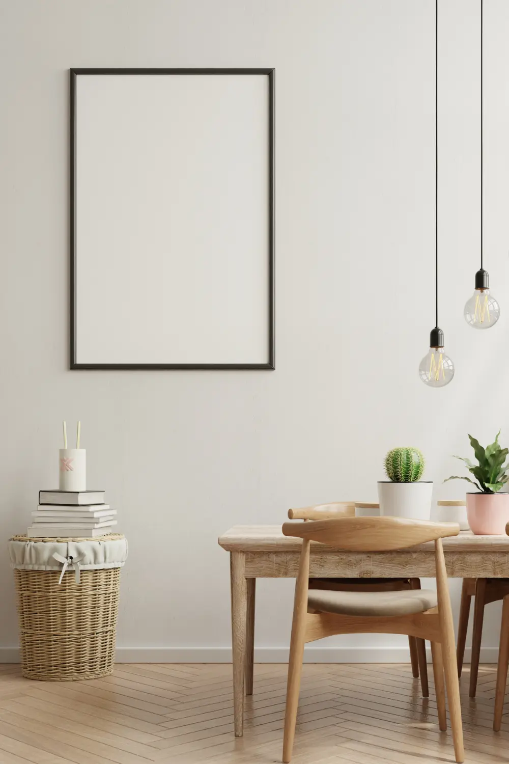 Small dining table with two wood chairs, pendant lights, and simple decor in a neutral apartment.