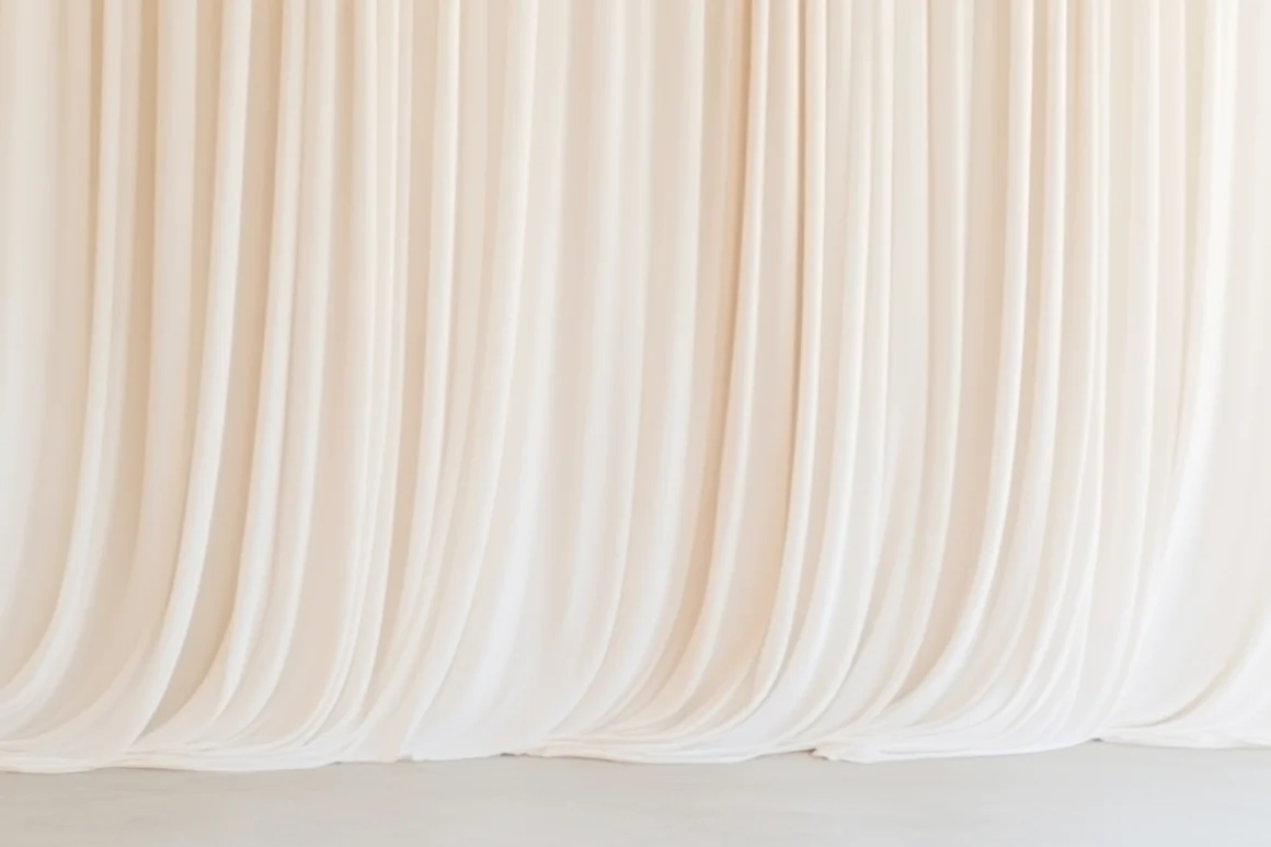 Soft sheer curtains filtering natural light, evoking calm, restraint, and the quiet pause that defines understated luxury.