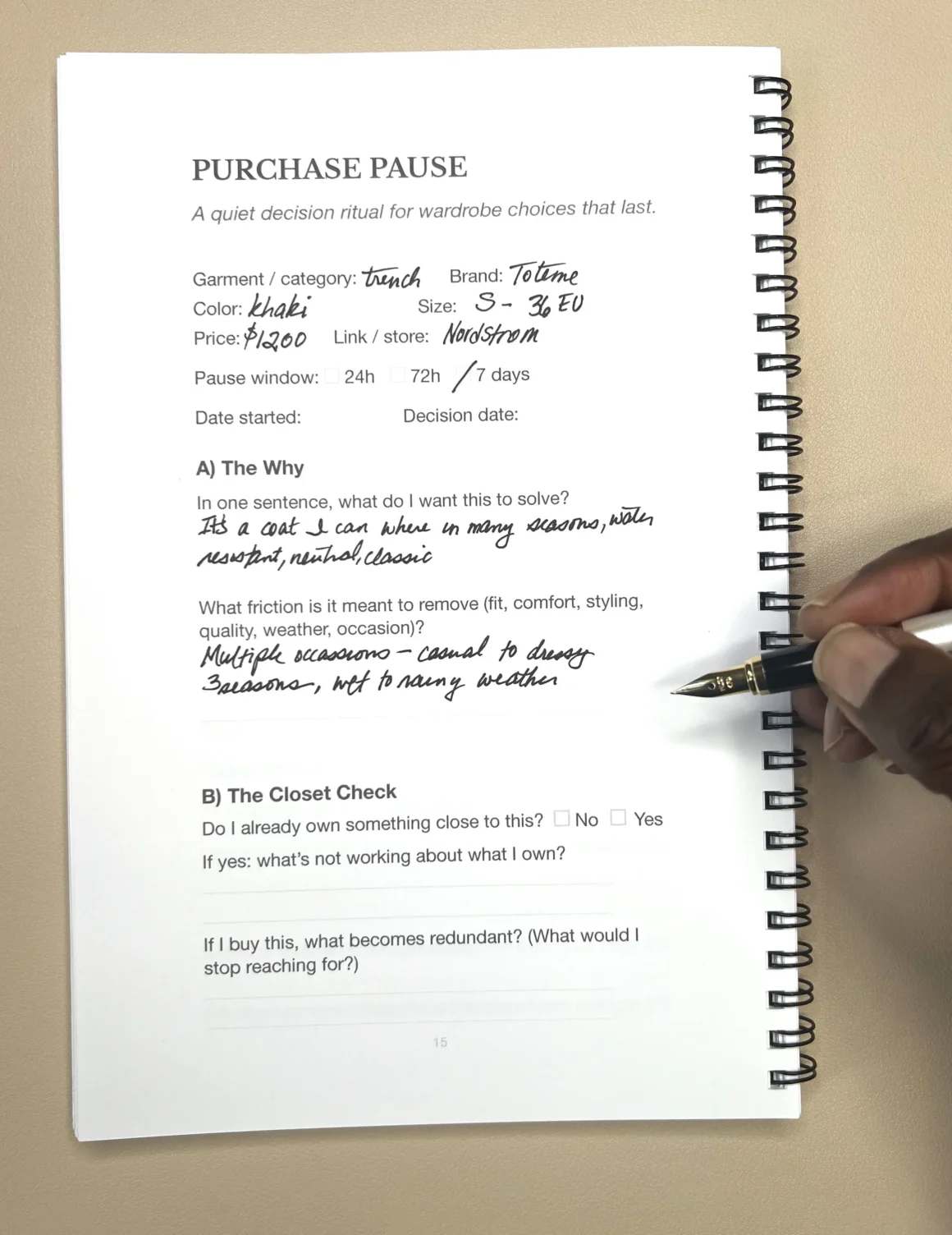 A hand writes in the Purchase Pause Journal while evaluating a potential wardrobe purchase in an effort to make better buying decisions.